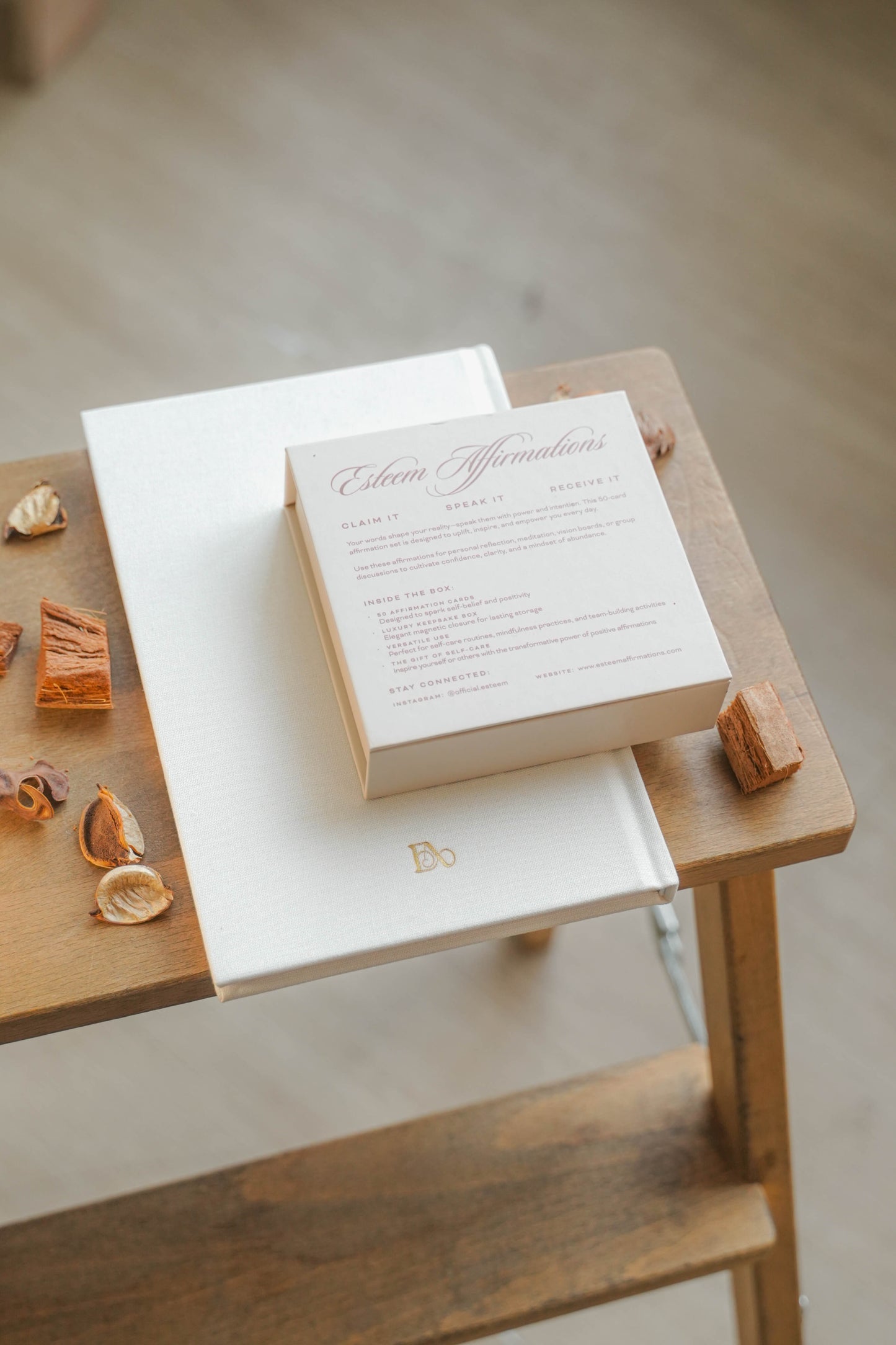 Wooden box with a white card on a wooden surface. Back of Claim speak receive affirmation cards and rewrite journal by Esteem Affirmations