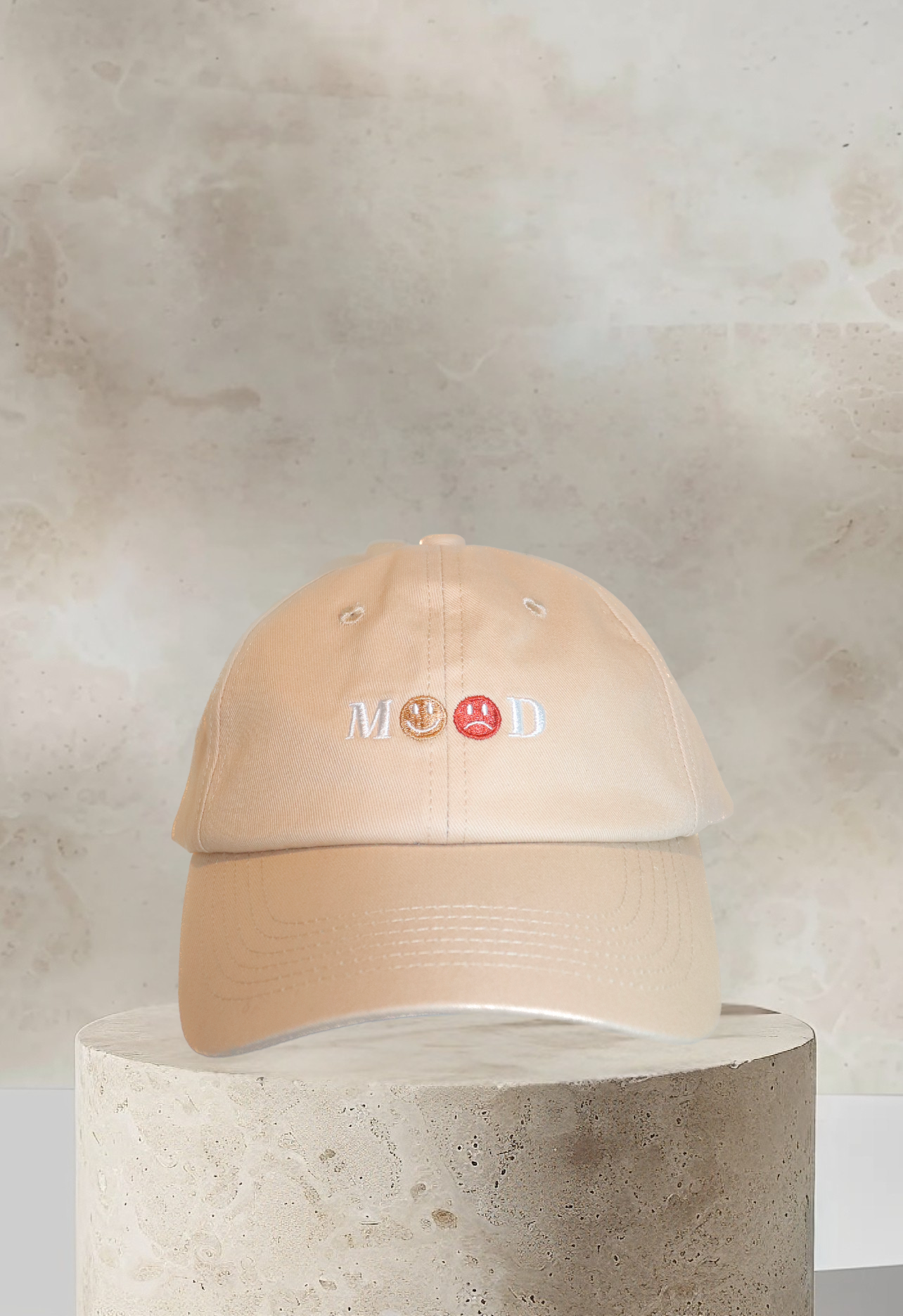 Tan embroidered MOOD dad hat with dual emotion faces on front panel