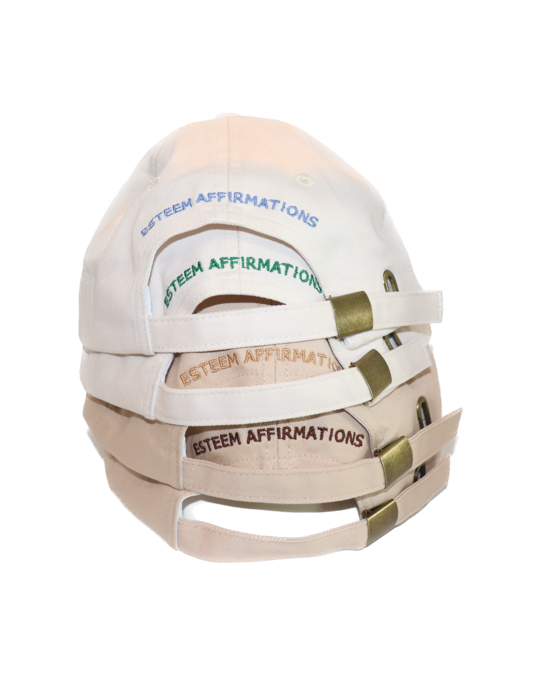 Stack of affirmation dad hats in various colors showing 'Esteem Affirmations' embroidered on the back of each cap