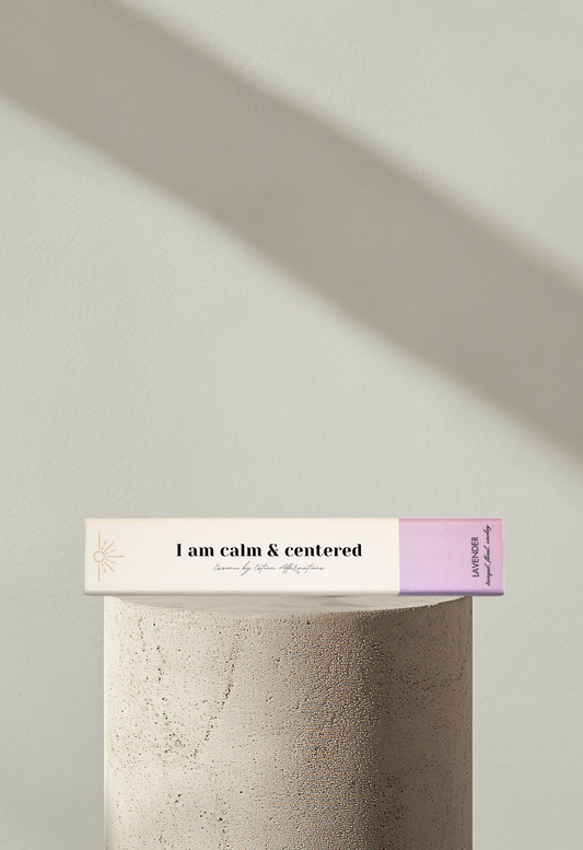 Wellness incense product showcased on a modern display podium with soft shadows and the affirmation I am calm & centered on the front box cover by Esteem Affirmations