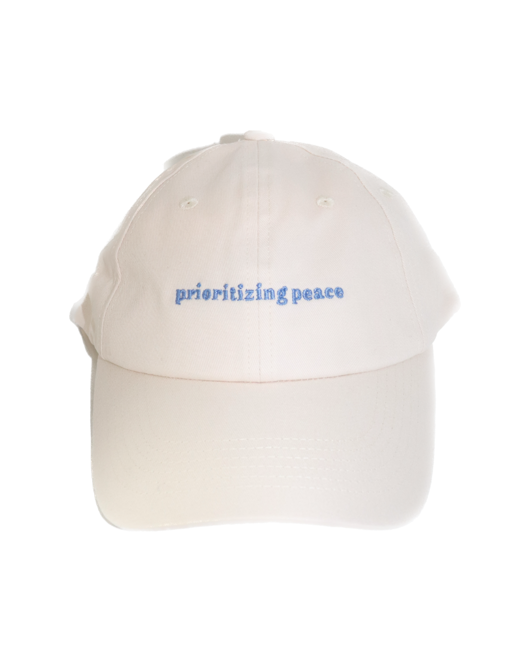 Close-up of 'Prioritizing Peace' embroidery in soft blue thread on cream cotton dad hat